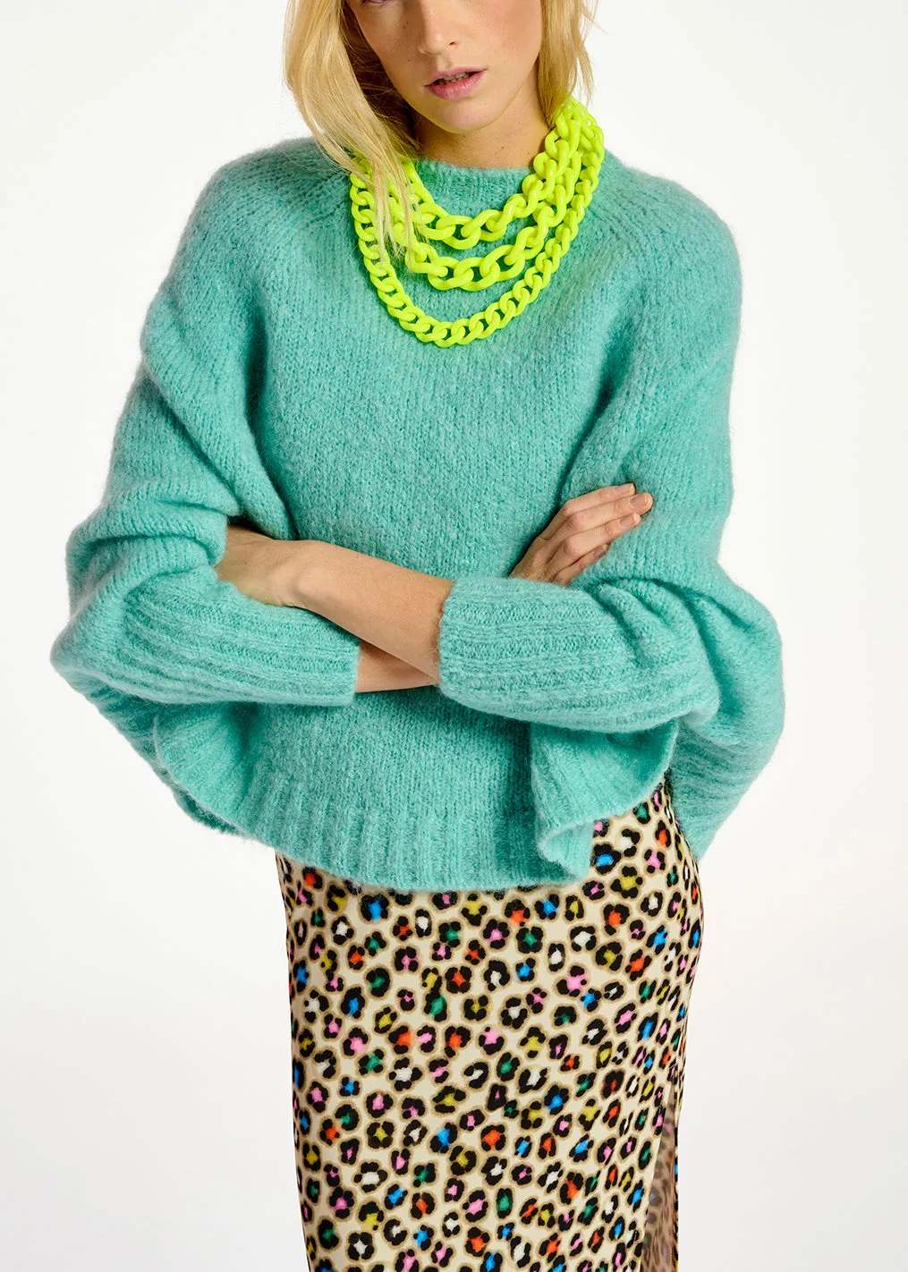 Turquoise knit sweater with cape effect