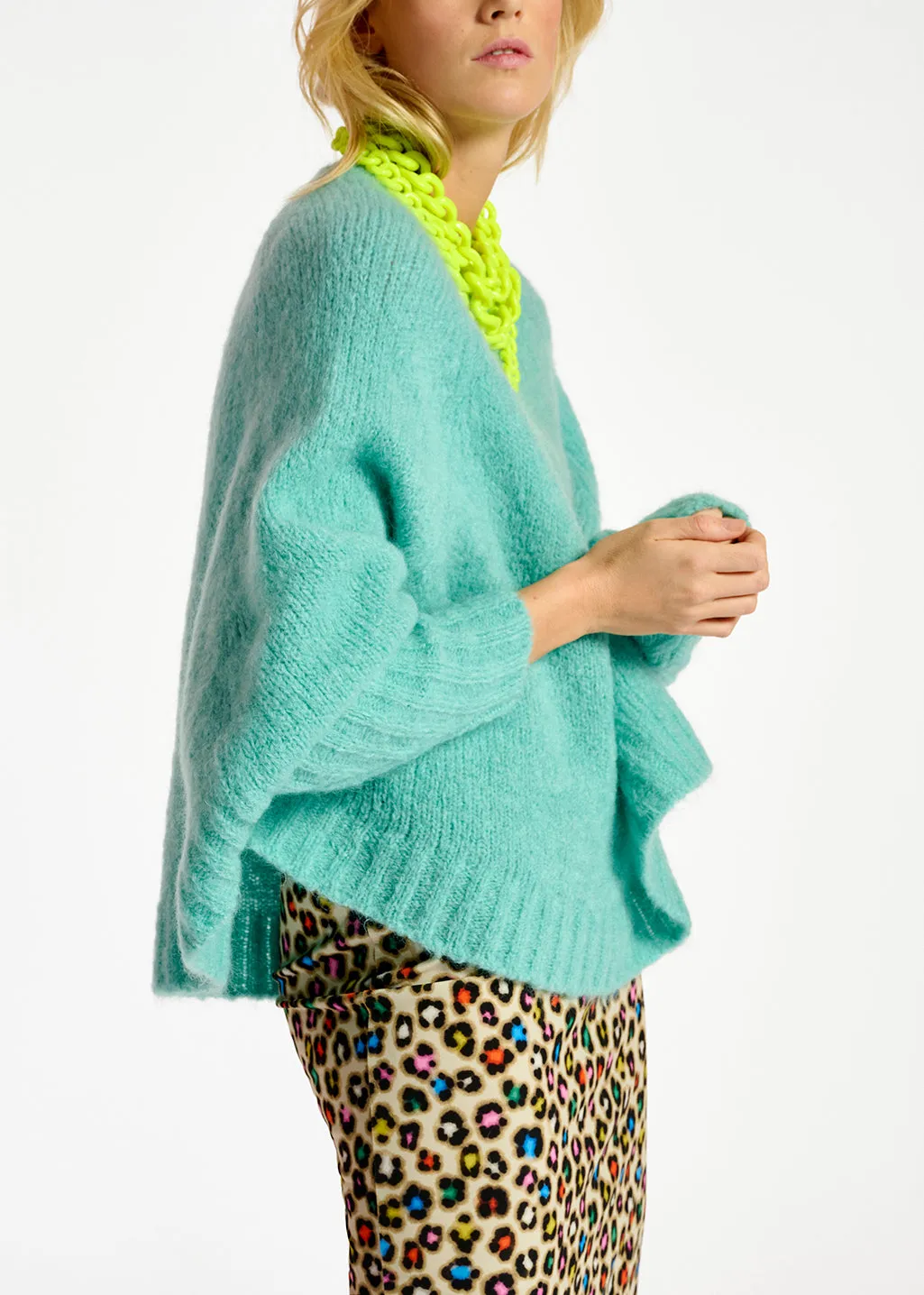 Turquoise knit sweater with cape effect